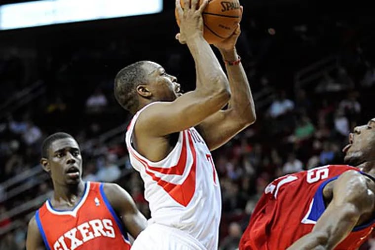 Rockets guard Kyle Lowrie gets fouled by Sixers forward Thad Young while driving the lane. (Pat Sullivan/AP)