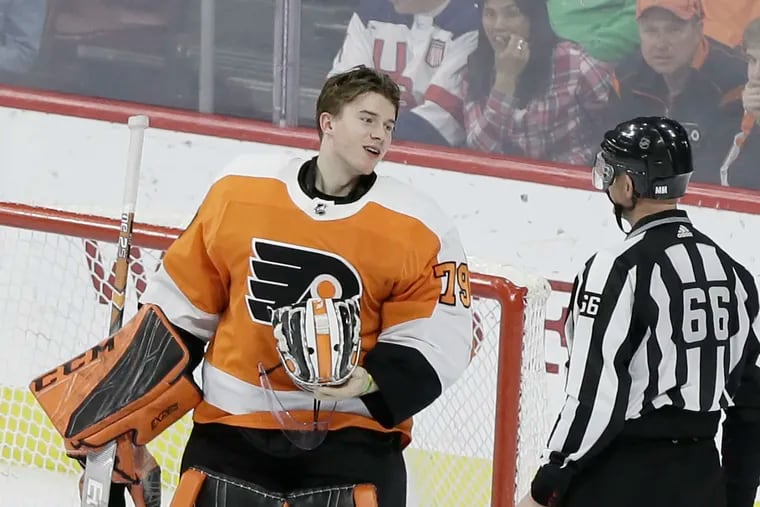 Carter Hart talks to an official after making a third-period save against the Capitals.