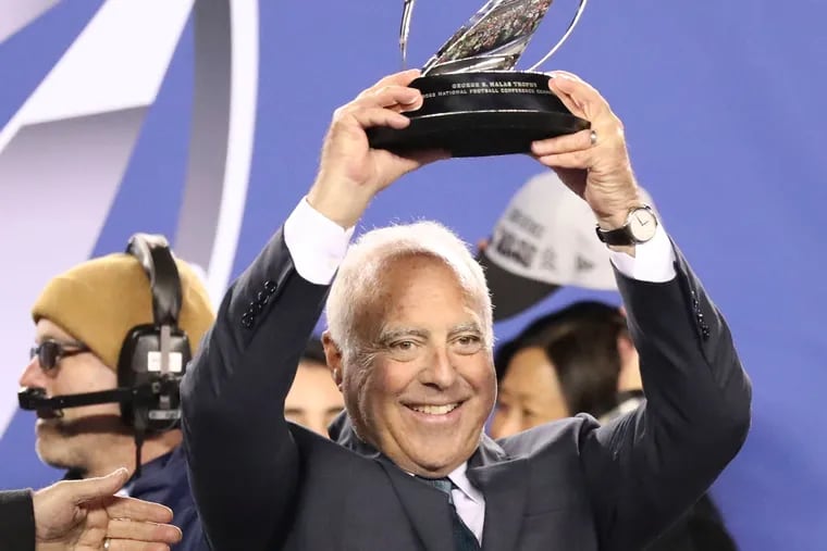 Eagles chairman Jeffrey Lurie holds up the George Halas Trophy after the Eagles' 31-7 victory Sunday in the NFC championship game.