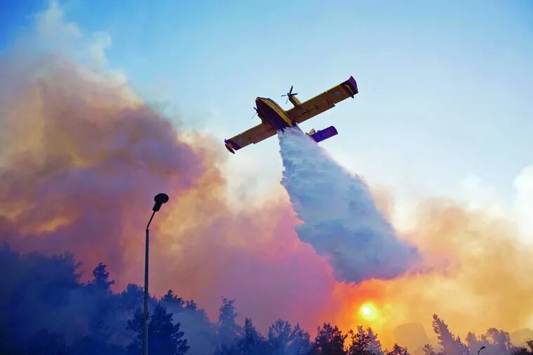 A firefighting plane from Greece fights the flames over Haifa, in northern Israel. Among the other nations helping with the effort are Russia and the United States.