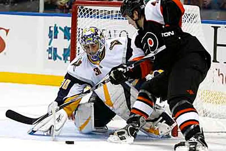 Buffalo Sabres goalie Ryan Miller makes a save on a shot by Philadelphia Flyers' Arron Asham (45) during the second period of the NHL hockey game in Buffalo, N.Y. (AP Photo/ David Duprey)