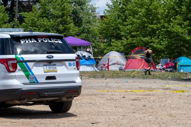 Police patrolling the area of an encampment outside the Philadelphia Housing Authority's headquarters.