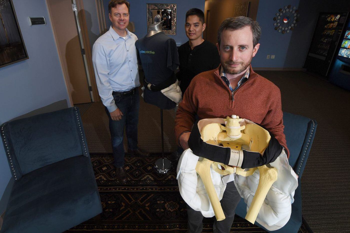 From left, Tango cofounder Drew Lakatos, Wamis Singhatat, vice president of product development, and Zane McKinney, product specialist, with Tango's patented airbag belt, designed to prevent fall-induced hip fractures, in 2018.