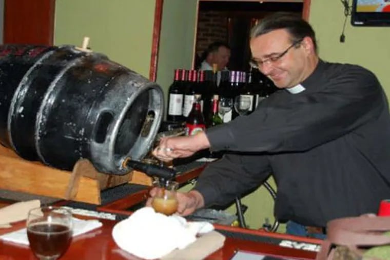 The Rev. Kirk Berlenbach of St. Timothy's Episcopal tapping the first keg of Gingerbread Jesus at Barren Hill Tavern & Brewery in Lafayette Hill.