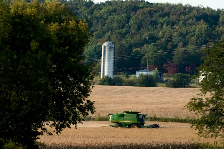 A combine harvests soybeans on a farm in Fairfield County, Ohio. The Department of Agriculture will cease all but essential functions during the shutdown, and no new rural loans or guarantees will be made.