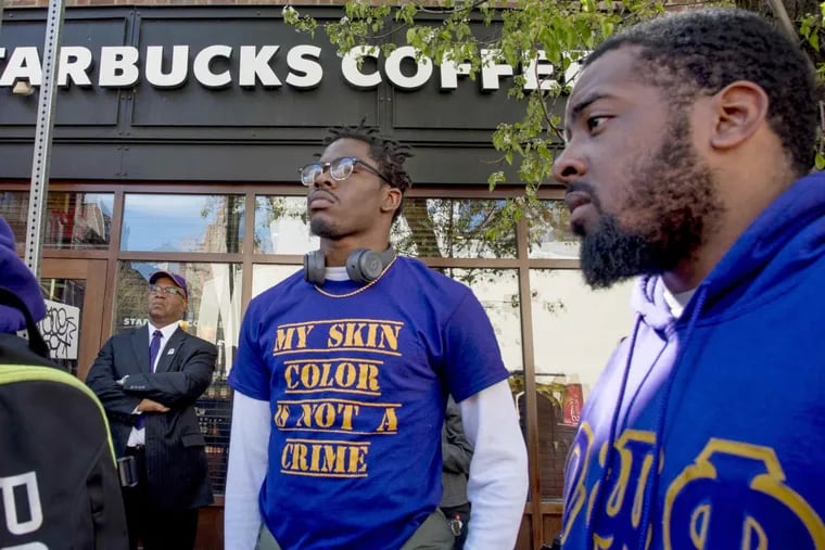 Bucketo Mitchell and Reese Tillman (right), members of the Omega Psi Phi fraternity at a rally April 22, 2018 outside the Starbucks where one of their fraternity brothers was one of the two black men arrested at Starbucks this month.