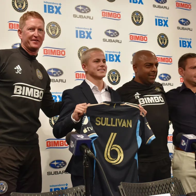 Union manager Jim Curtin, Cavan Sullivan, reserve team coach Marlon LeBlanc, and academy director Jon Scheer (from left to right) pose for a photo as Sullivan holds up his new No. 6 jersey after a news conference Thursday at Subaru Park.