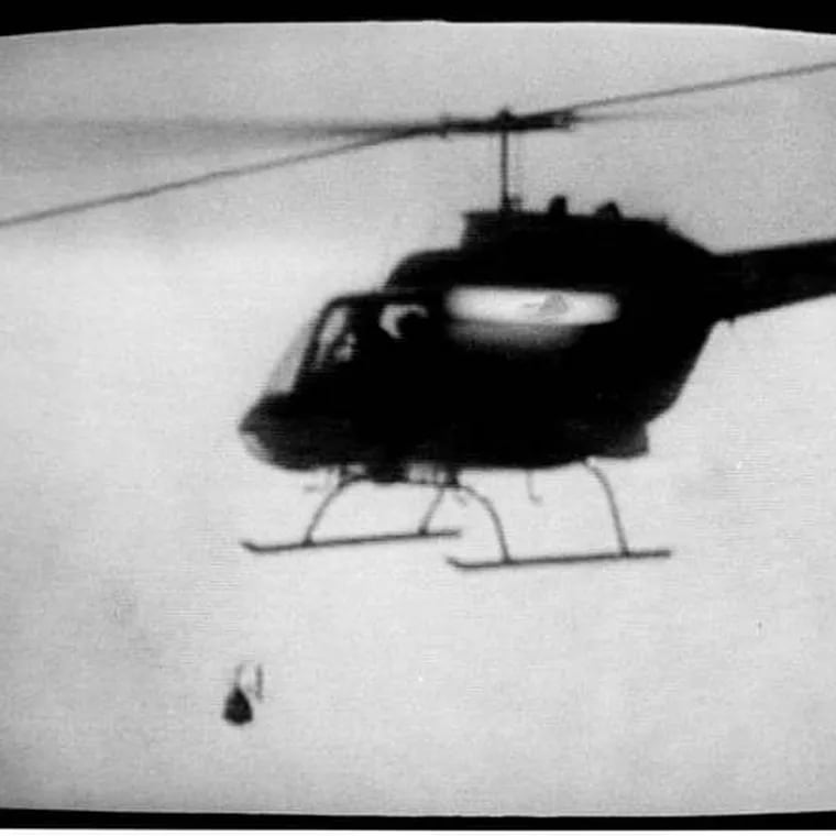 Police helicopter dropping the bomb on the MOVE rowhouse in Philadelphia in May 1985. Image captured from television footage shot by WCAU-TV.