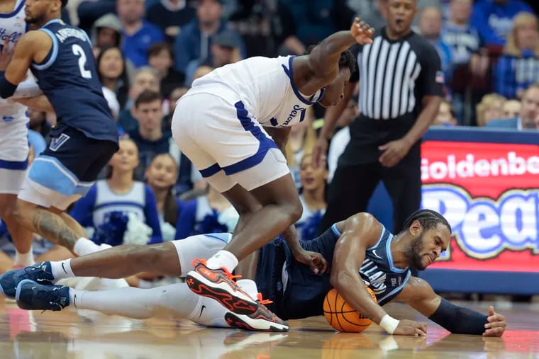 Eric Dixon, right, of Villanova and Kadary Richmond of Seton Hall go after a loose ball during the 2nd half on March 6, 2024 at the Prudential Center in Newark, N.J.