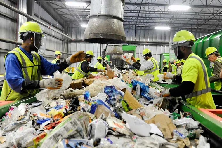 Nonrecyclables — mostly plastic bags — are removed at Waste Management’s recycling facility in Northeast Philadelphia, which opened in 2011. A two-alarm fire was reported at the facility on Sunday.