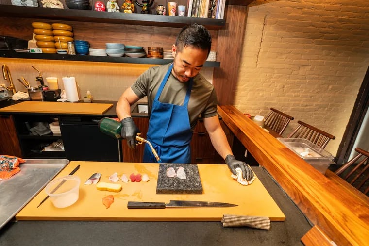 Chef-owner Jesse Ito wielding his blowtorch at the omakase counter at Royal.