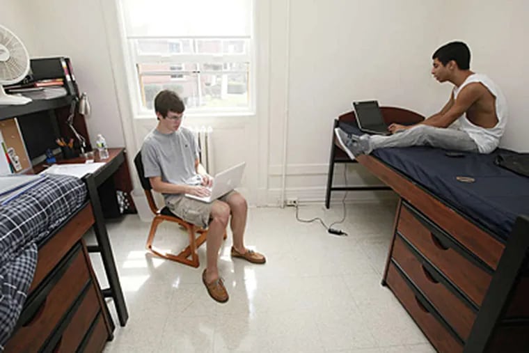 Daniel Sullivan (left) and Fernando Rivera connect to the Internet during move-in day at Centenary College in New Jersey last Saturday. (Associated Press)