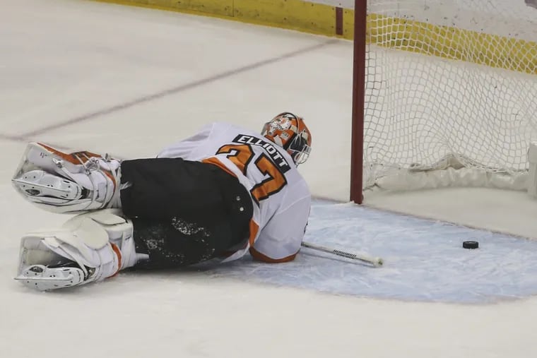 Flyers goalie Brian Elliott is down after Carl Hagelin’s first-period goal in the Penguins’ 7-0 Game 1 romp.