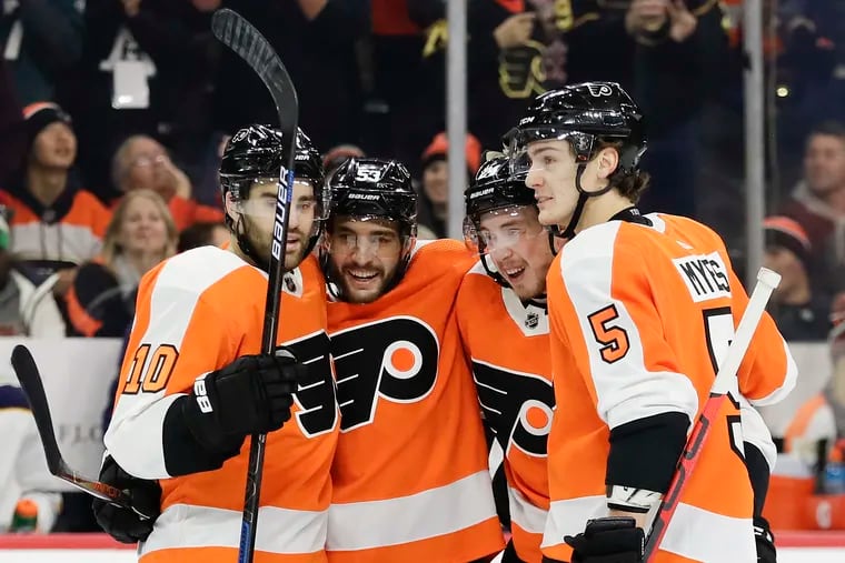 Flyers center Misha Vorobyev (second right) celebrates his first-period goal Thursday with teammates (left to right) Andy Andreoff, Shayne Gostisbehere, and Phil Myers. The Flyers routed the Sabres.