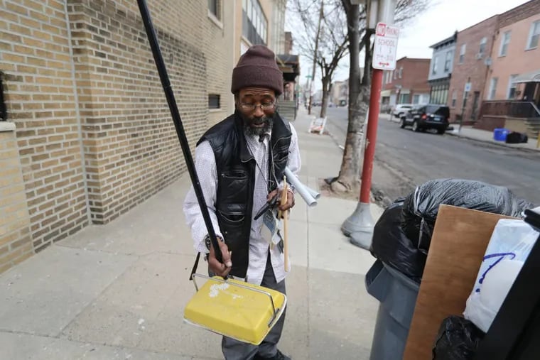 Ogbonna Hagins hunts for treasure on Ninth Street in South Philadelphia including a sweeper.