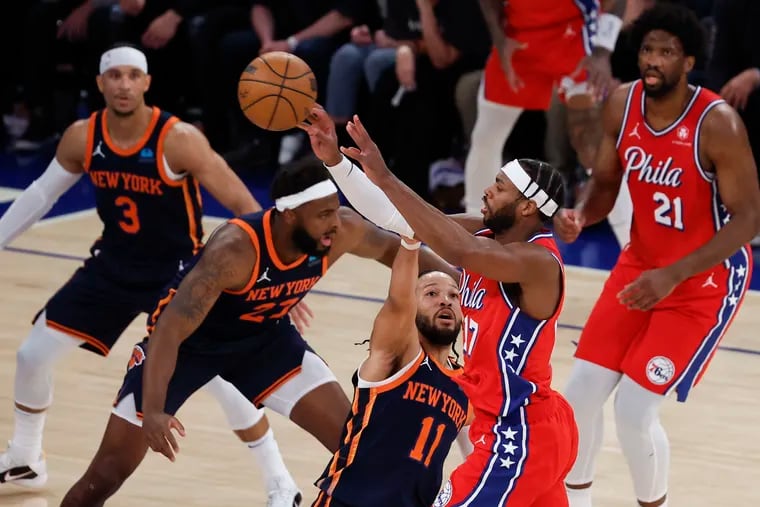 New York Knicks guard Jalen Brunson (11) defends Sixers guard Buddy Hield as his teammate and fellow Villanova alum Josh Hart (3) looks on during Game 2 of the first round NBA Eastern Conference playoffs on Monday.