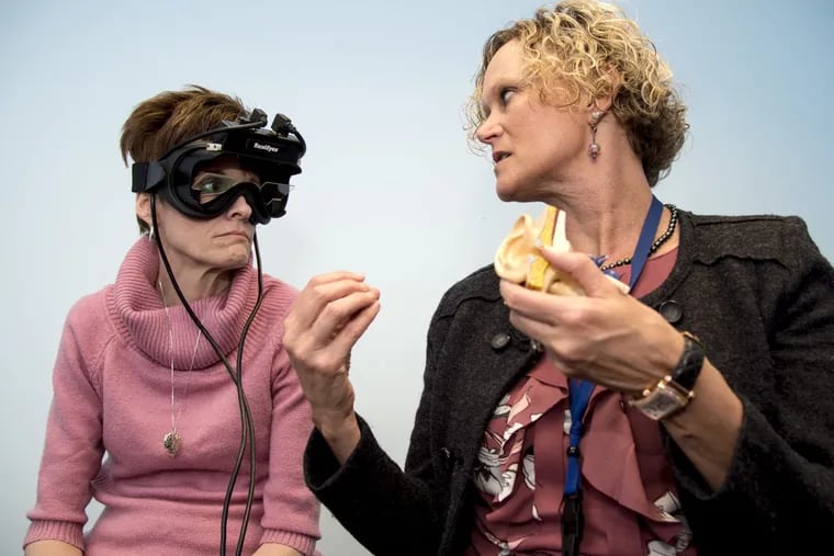 Wendy Webb Schoenewald (right), who specializes in treating inner-ear disorders, talks to vertigo patient Ann Marie Shumsky, who is wearing a pair of infrared goggles that can help in diagnosis.