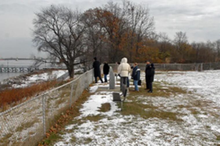 Preservationists stand near historic markers in a public park near Fort Billingsport&#0039;s Delaware River site. They say they believe the fort was on higher ground, behind the oil-terminal fence.