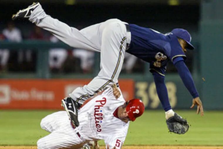 Carlos Ruiz tries to break up doubleplay, but Brewers&#0039; Rickie Weeks still was able to turn it.