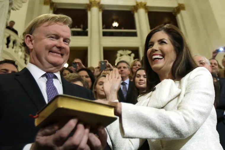 Kathleen Kane, accompanied by her husband Christopher, takes the oath of office for Pennsylvania Attorney General on Jan 15, 2013. Kane, who has already endured a tough year professionally, has filed for divorce after 14 years of marriage, saying her union is irretrievably broken.