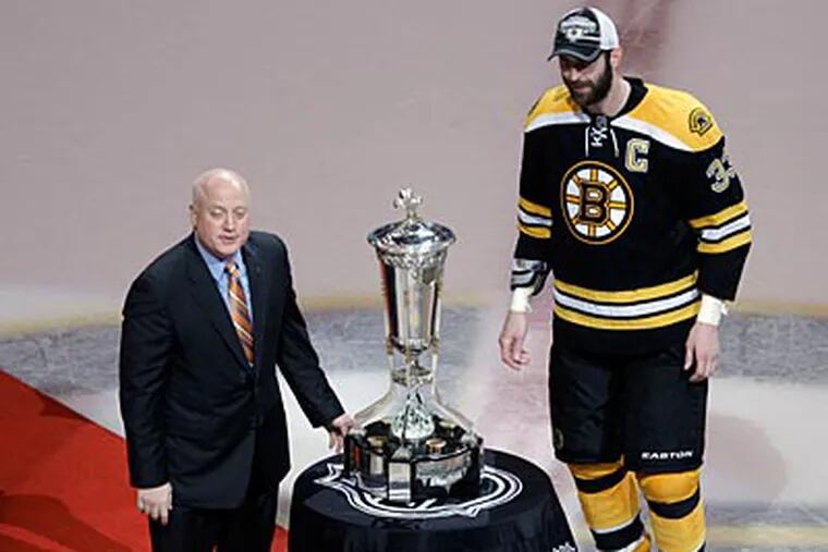 NHL deputy commissioner Bill Daly presents the Prince of Wales Trophy to Zdeno Chara on Friday. (Charles Krupa/AP Photo)