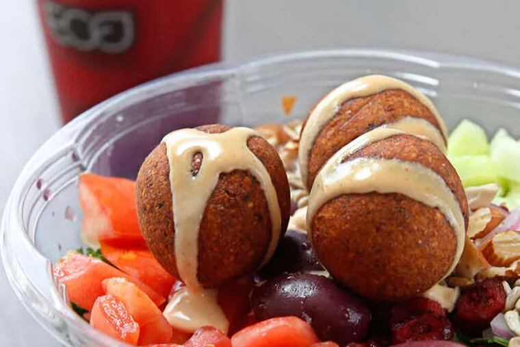 The falafel salad with red Recharge juice in background.  ( Michael Bryant / Staff Photographer )
