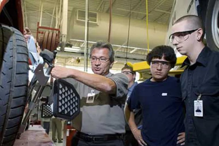 Instructor Steve Bruno, left, demonstrates an alignment machine at the new garage at Western Montgomery Career and Technology Center. Watching are Zach Ludwig, rear, Dario Verdin, second from right and Dylan Richardson, right. (Ed Hille / Staff Photographer)