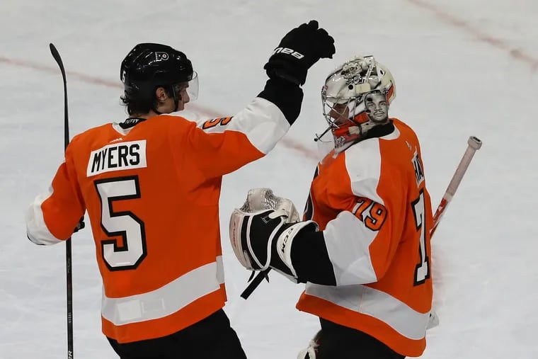 Goalie Carter Hart (right) is congratulated by Phiilippe Myers aftet their 4-1 victory over the Hurricanes.