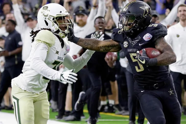 Harrison Hand trying to stop Vanderbilt running back Ke'Shawn Vaughn during the Texas Bowl in December. Hand, a former South Jersey star, is transferring to Temple.