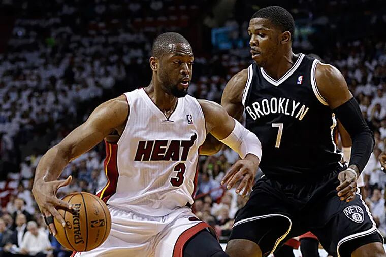 The Heat's Dwyane Wade drives to the basket as Nets guard Joe Johnson defends. (Lynne Sladky/AP)