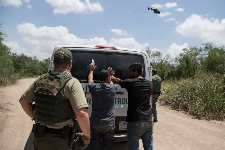 A group of men who crossed the U.S. border illegally and tried to run from Border Patrol agents are detained in Mission, Texas, on Aug. 15, 2018.