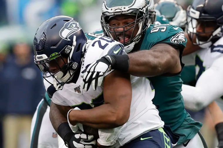 Eagles defensive tackle Fletcher Cox stops Seattle Seahawks running back Rashaad Penny in 2019.