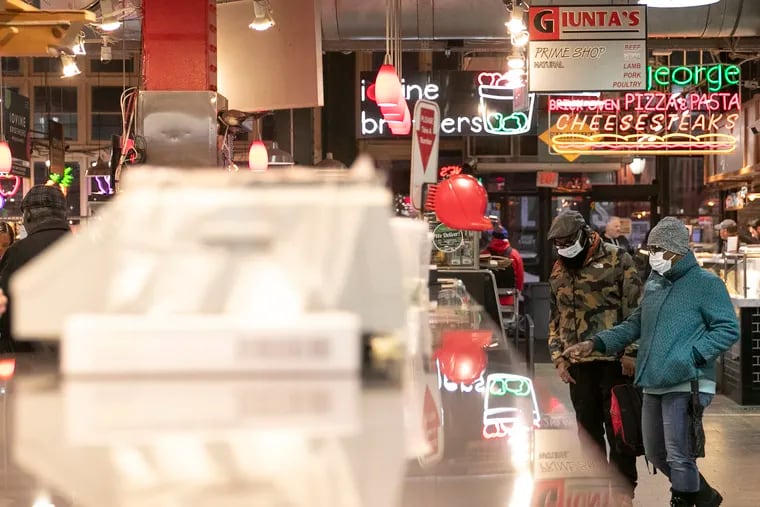 People weigh their options inside Reading Terminal Market on Wednesday, March 25, 2020. Gov. Tom Wolf called for the closure of all businesses that are not "life-sustaining," due to the spread of the coronavirus. Restaurants are now takeout or delivery only.