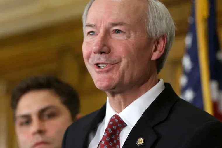 Arkansas Gov. Asa Hutchinson responds to reporters' questions. He said his own son signed a petition against the bill.
