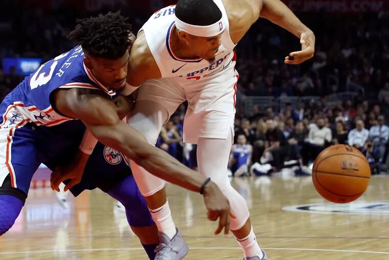 Jimmy Butler (left) battles the Clippers' Tobias Harris during the Sixers' win in Los Angeles on Tuesday.