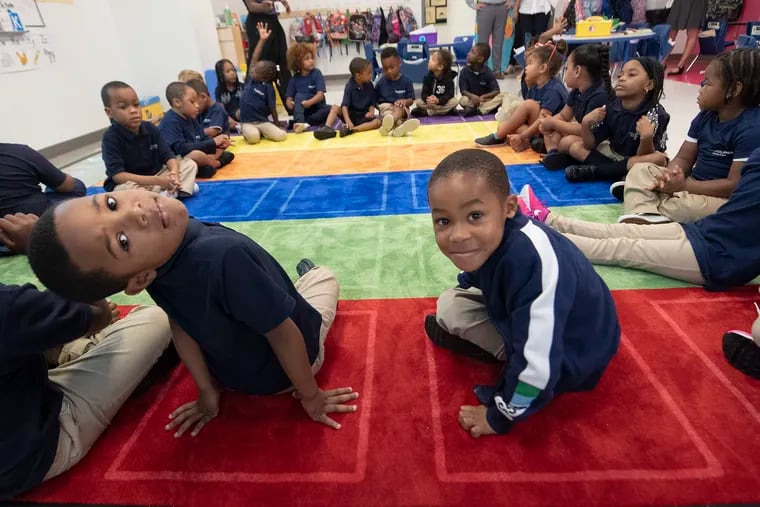 Kindergarten students, Aiden Swaayze, left, and Liam Romero, right, look back during circle time at the Philadelphia Hebrew Public Charter School last week. Philadelphia Hebrew opened this month and is a charter school that teaches modern Hebrew to students.