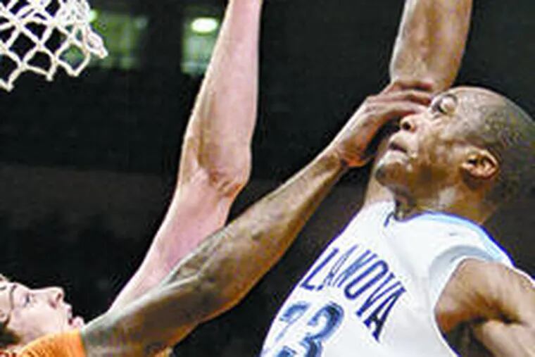 Villanova&#0039;s Dante Cunningham (right) is fouled by Texas&#0039; Damion James while shooting over Clint Chapman in the first half. Cunningham was the only consistent Wildcat at the offensive end, accounting for 23 points.