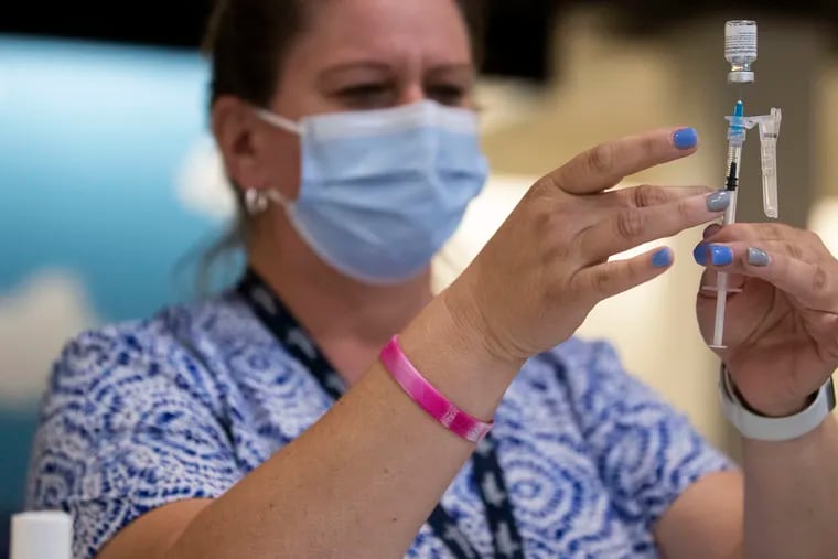 A nurse prepares vaccines at the King of Prussia Mall on Wednesday, May 12, 2021.
