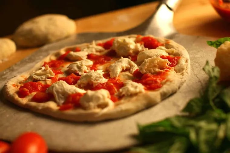 Pizza is about as close to a perfect food as can be found and is easily made at home where you can personalize with your favorite toppings. (E. Jason Wambsgans/Chicago Tribune/MCT)