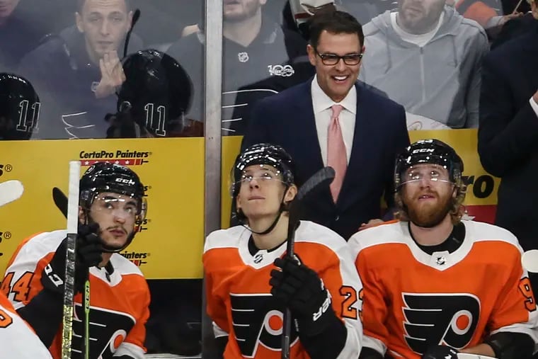 Flyers interim head coach Scott Gordon smiles during a review of a goal against the Red Wings on Dec. 18. He is more vocal and fiery than his predecessor, Dave Hakstol.