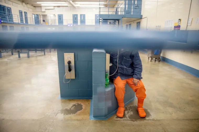 A detainee talks on the phone in his pod at the Stewart Detention Center in Lumpkin, Ga.