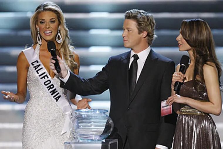 Hosts Billy Bush, center, and Nadine Velazquez, right, listen as Miss California Carrie Prejean, left answers a question from judge Perez Hilton, unseen, about legalizing same-sex marriage. (AP Photo/Eric Jamison)