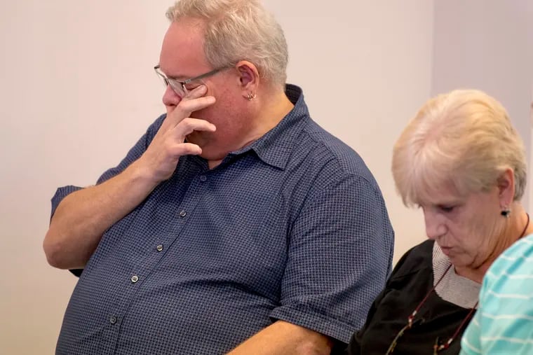 Joseph German (left) tears up as he listens to others describe conditions at the George W. Hill Correctional Facility at a round-table discussion Sunday hosted by the Delaware County Coalition for Prison Reform. Susanne Wallace (right) spoke about her daughter, Janene, who committed suicide inside her cell.
