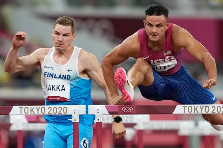 Devon Allen competes alongside Elmo Lakka, of Finland, in a men's 110-meter hurdles heat at the Summer Olympics in Tokyo in 2021.