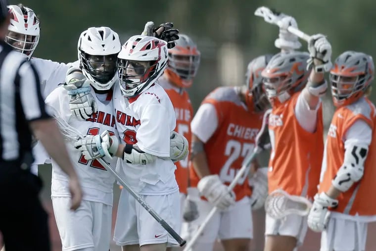 Lenape’s # 12 Bryce Reece (left) is hugged by Sean Shelko after scoring, what was eventually the winning goal, in the fourth quarter of the Cherokee at Lenape H.S. South Jersey Group 4 semifinal boys lacrosse match on May 22, 2019. Lenape won the game 11-10.