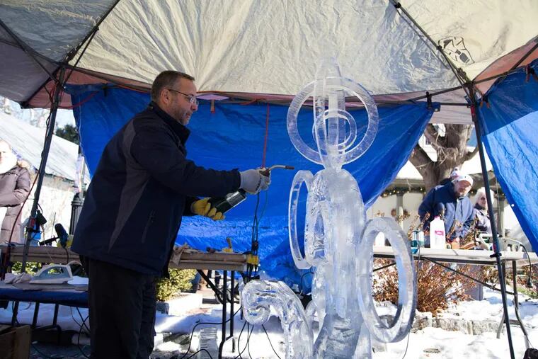 Robert Lo Furno, 55, fires his sculpture, The Rings of Life, at the 2016 Fire and Ice Festival in Mount Holly, New Jersey, Saturday, Jan. 30, 2016. Lo Furno and his family, who call themselves an "ice-carving family," have been competing in the festival for more than 10 years.