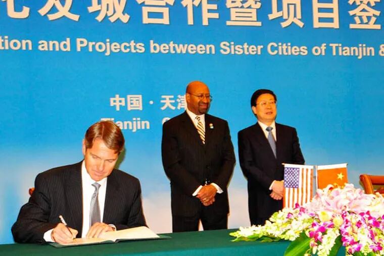 At a signing ceremony attended by Mayor Nutter and his Tianjin counterpart, Gary Biehn, a partner with the Philadelphia law firm of White and Williams, signs a strategic alliance agreement with LI Haibo, founder of the Winners Law Firm in Tianjin. Jennifer Lin / Staff