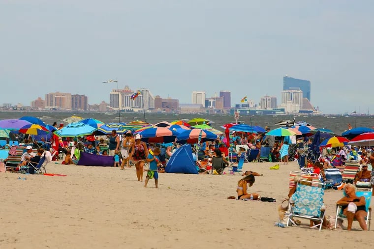 The beach was crowded Friday to start Labor Day weekend in Ocean City, N.J., but many worried about a stormy finish.