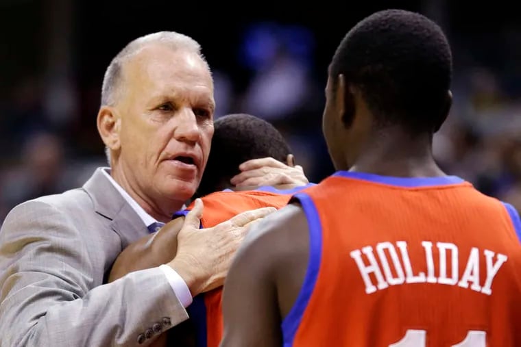 Doug Collins hugs Thaddeus Young before the final game of the season. Collins said he was not sure whether he would return as the 76ers' coach.