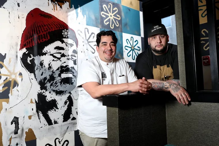 Chef Jose Garces, left, and Steven Seibel at Hook & Master. The artwork behind them is a mural of Bill Murray's title character from the movie "The Life Aquatic with Steve Zissou," created by Philadelphia artist Nero.